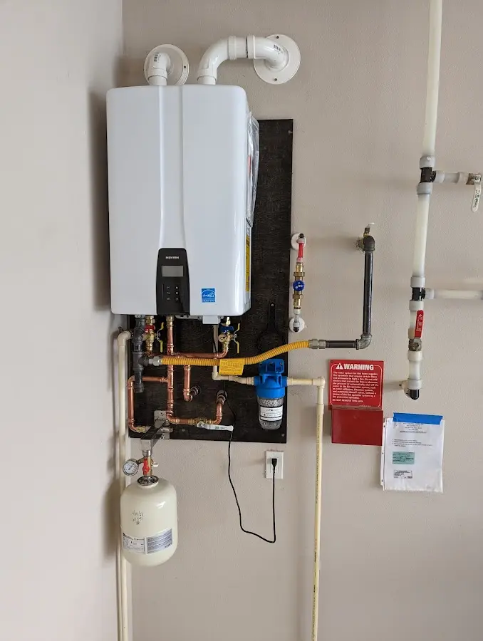 Professional plumber installing copper piping in a Chelsea home